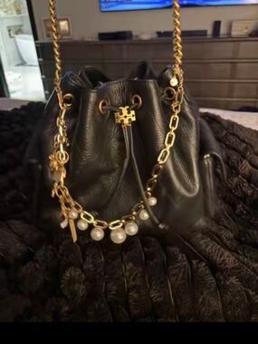 Tory Burch Black Leather Drawstring Bucket Bag with Gold Chain and Pearl Accents
